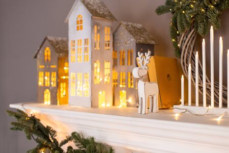 Closeup of paper holiday decorations standing on white fireplaceの写真素材