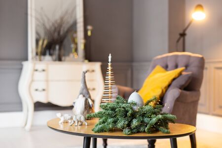 Exposition of little table decorated with Christmass toys with chair and mirror on background. Selective focusの写真素材