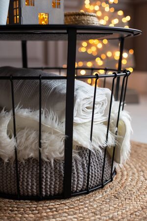 White and gray plaids lay under the table. Cozy atmosphereの写真素材