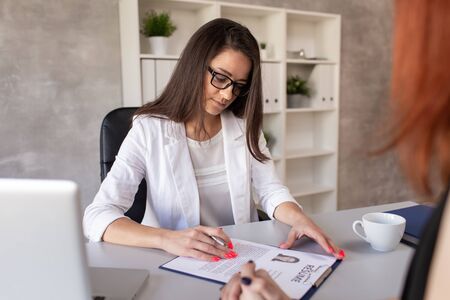 Confident manager listen candidate for a job in company who tells about herself at job interview. Selective focusの写真素材