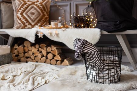Basket with two blankets inside stand in front of wooden bench. Selective focusの写真素材