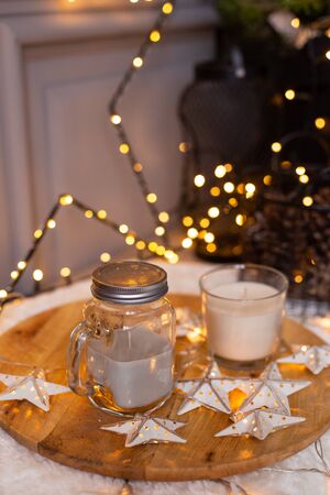 Closeup of jar of milk and mug siting on a tray with stars. Holiday atmosphereの写真素材