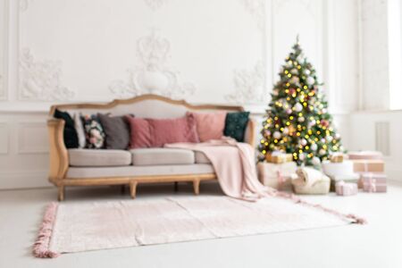 Blurred photo of modern living room with Christmas tree and sofa insideの写真素材