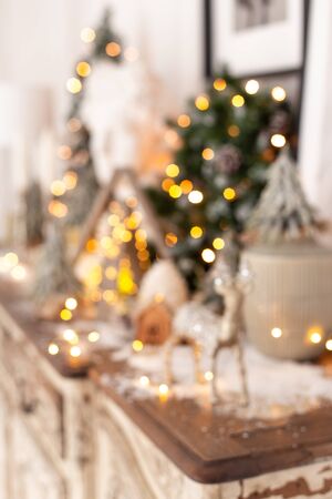 Blurred image of Christmas decorations standing on wooden deskの写真素材