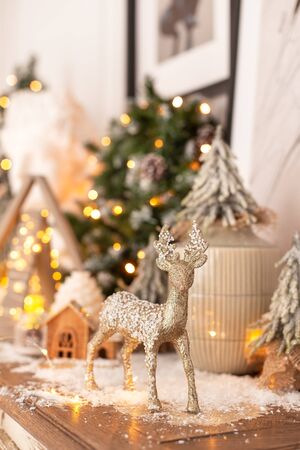 Closeup of wooden deer standing on background of Christmas decoration. Selective focusの写真素材