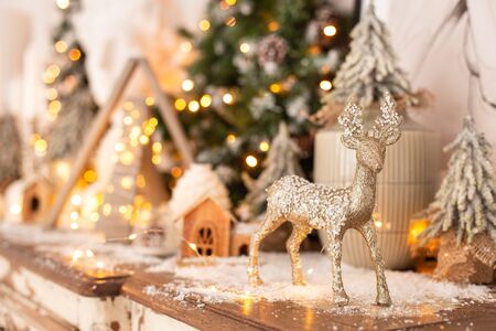 Closeup of wooden deer standing on background of Christmas decoration. Selective focus.の写真素材