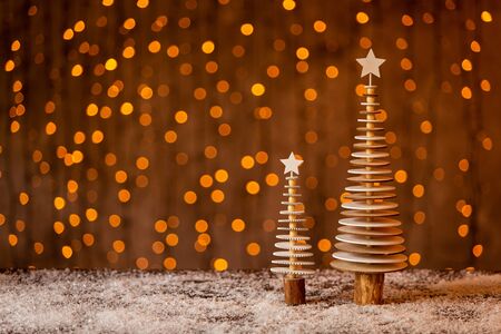 Two tiny firs made of wooden circles with stars on top. Selective focusの写真素材