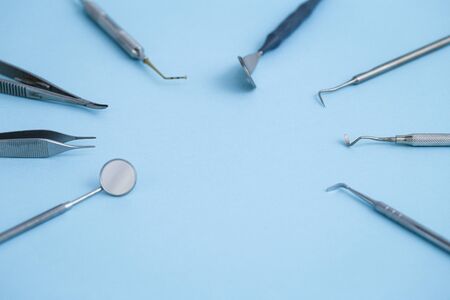 Dental equipment laying in circle on blue backgroundの写真素材
