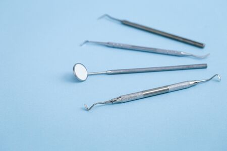 Closeup of set of dental instruments on blue backgroundの写真素材