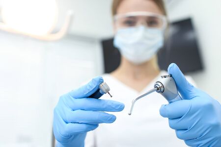 Closeup of dental instruments in hands of doctor. Selective focus.の写真素材
