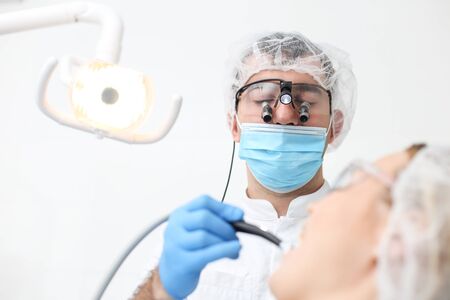 Dentist checkup procedure with female patient on chair. Selective focus.の写真素材