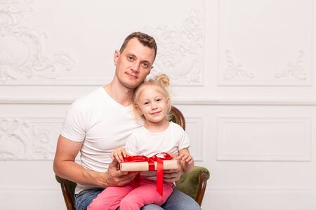 Happy father and his daughter holding gift box and smile. Fathers day. Selective focusの写真素材