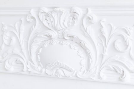 Beautiful ornate white decorative plaster moldings in studio.