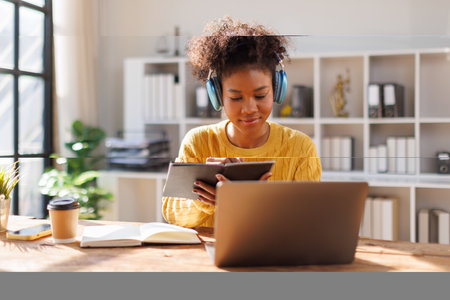 Portrait of teenage woman using laptop computer at home.