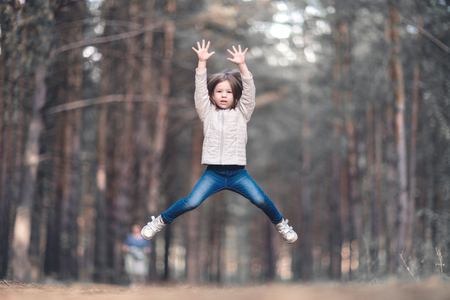 Little girl jumping and having fun outdoorsの写真素材