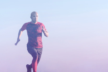 Sporty young man running outdoors. Healthy lifestyle, fitness, sport and weight loss conceptの写真素材