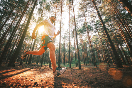 Running man. Male runner jogging at the park. Guy training outdoors. Exercising on forest path. Healthy, fitness, wellness lifestyle. Sport, cardio, workout conceptの写真素材