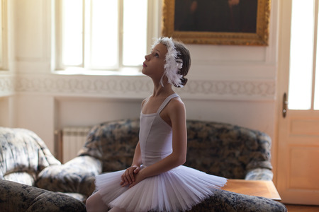 young ballerina posing on a sofaの写真素材