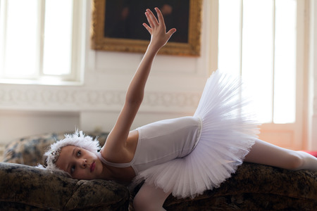 young ballerina posing on sofaの写真素材