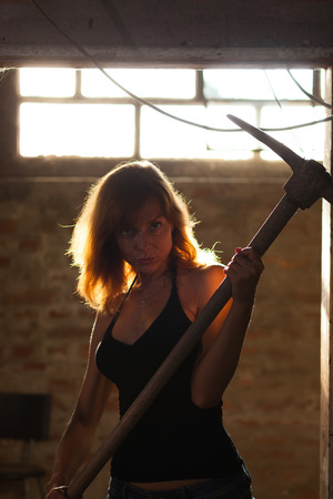 beautiful young woman posing with pickaxの写真素材