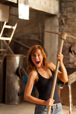 beautiful young woman posing with pickaxの写真素材