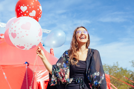 young woman with many balloonsの写真素材