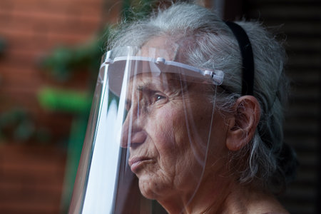old woman wearing a protective visorの写真素材