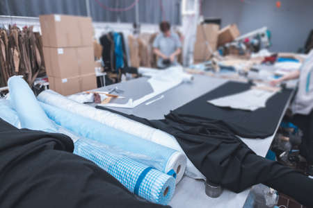 clothing manufacturing facility with fabric on tableの写真素材