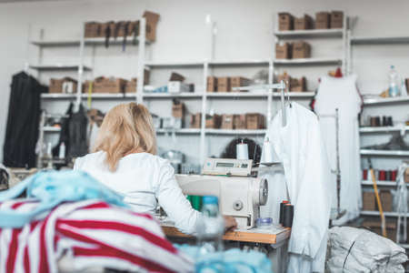 clothing industry worker working on sewing machineの写真素材