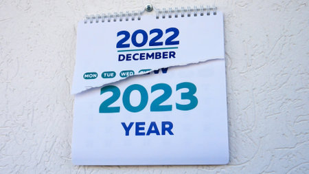 Close-up of the half-torn December page of a wall calendar 2022 followed by the title page of a new 2023 calendarの写真素材