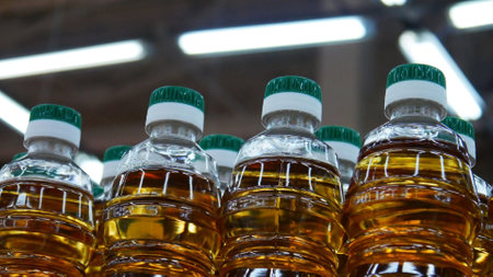 Close-up of many plastic bottles of oil or apple vinegar in a store