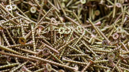 Close-up of a big pile of beautiful golden screws