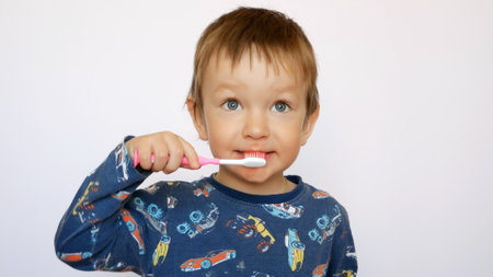 A cute baby boy brushes his teeth