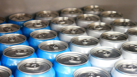 Close-up of many beautiful white-blue cans of beer on a store shelf