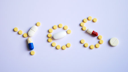 Close-up of the word YES made of different medicines on a white surfaceの写真素材
