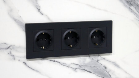 Close-up of a block of electrical outlets in a marble wallの写真素材
