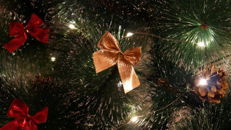 Close-up of a nice golden bow hanging on a Christmas tree