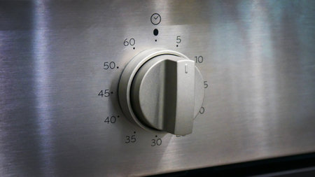 Close-up of the steel knob of an ovenの写真素材