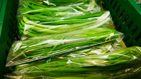 Many packaged bunches of green onions