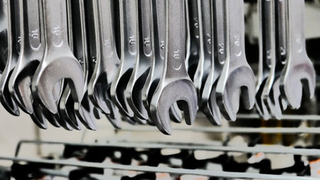 Many different sizes wrenches hanging on a store stand close-upの写真素材