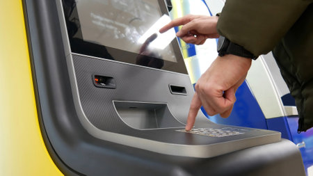A man using an ATM close-upの写真素材