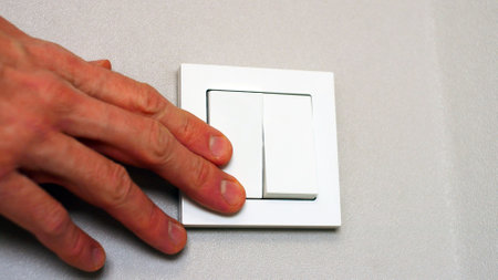 Close-up of male hand turning on the light