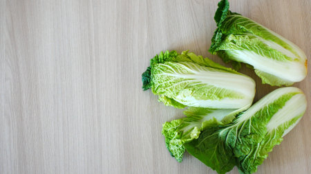 Three nice Chinese cabbages on a wooden surfaceの写真素材