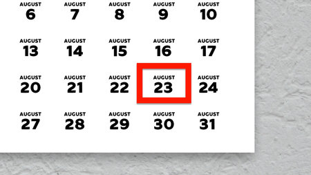 Close-up of the date August 23rd marked with a red cursor on the wall calendar 2025