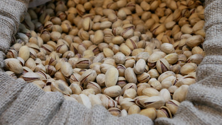 Lots of beautiful pistachios in shell in a canvas bag