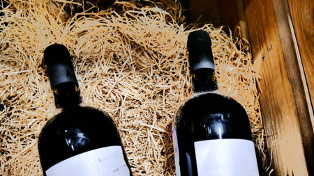 Two bottles of wine in a wooden box with packging filler