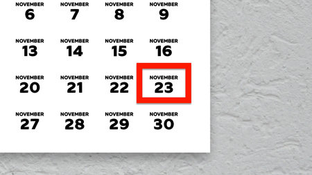 Close-up of the date November 23rd marked with a red cursor on the wall calendar 2025