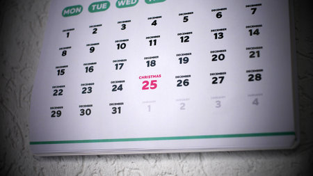 The focus on the date of Christmas 2025 highlighted on a wall calendar close-upの写真素材