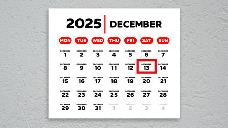 The date December 12th marked with a red cursor on the wall calendar 2025