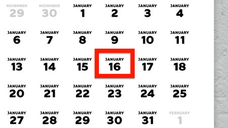 Close-up of the date January 16th marked with a red cursor on the wall calendar 2026